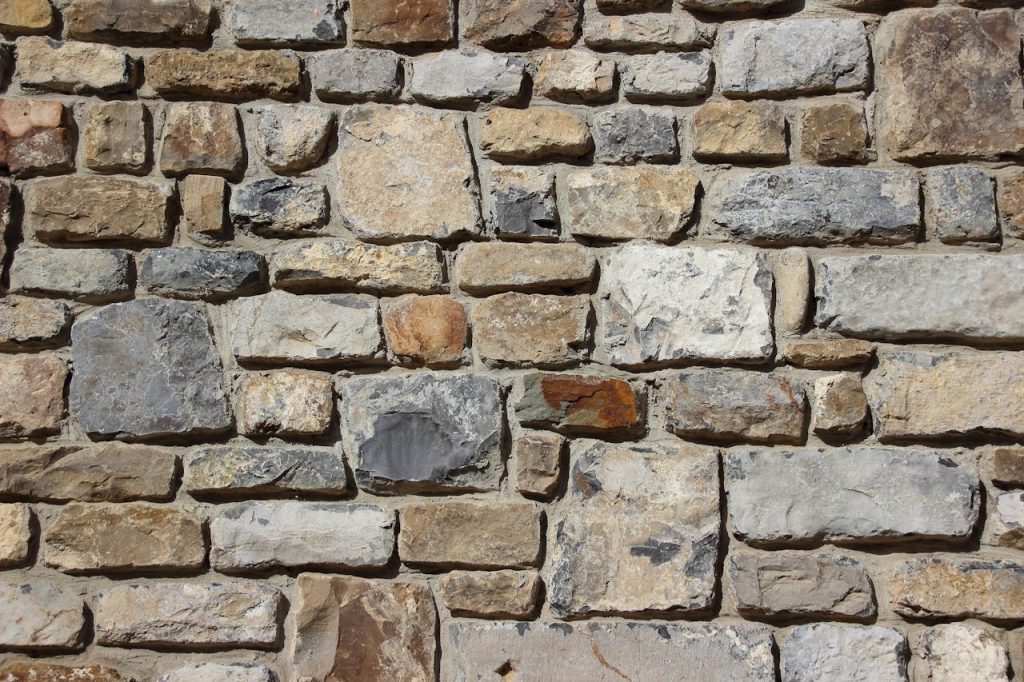 Detailed image of a textured stone wall, showcasing various shades and shapes.